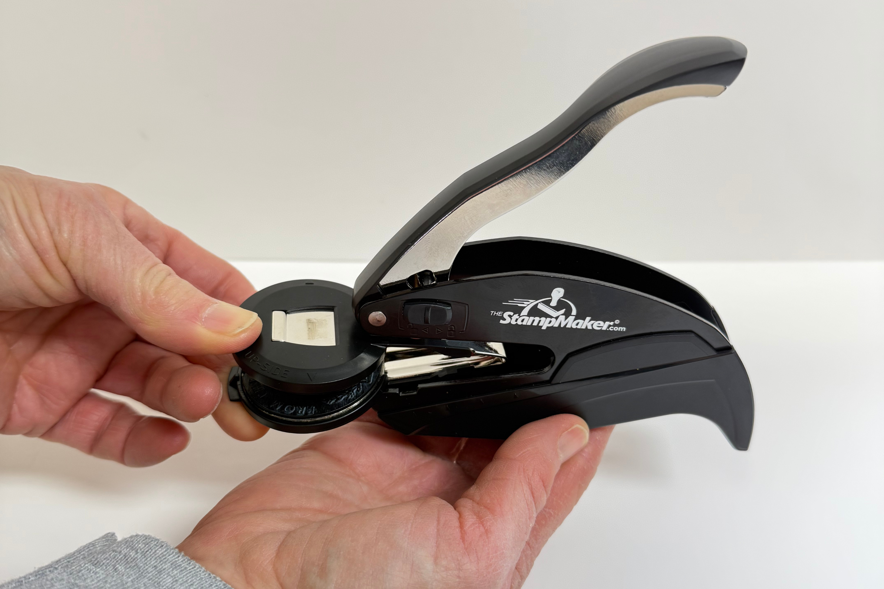 Pinch the clip to remove it from the embosser